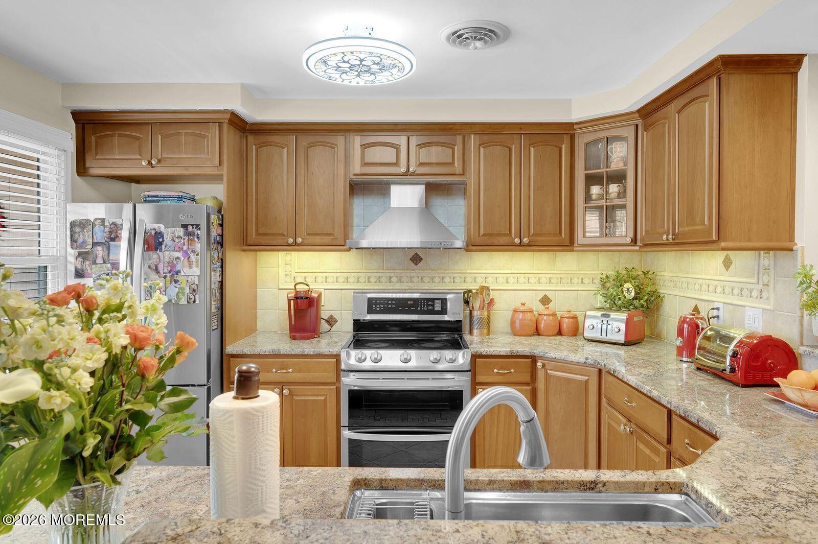 7 Eaton Lane, Unit 73 Whiting, NJ 08759 - Photo 15 of 37 a kitchen with stainless steel appliances granite countertop a stove a sink and a microwave