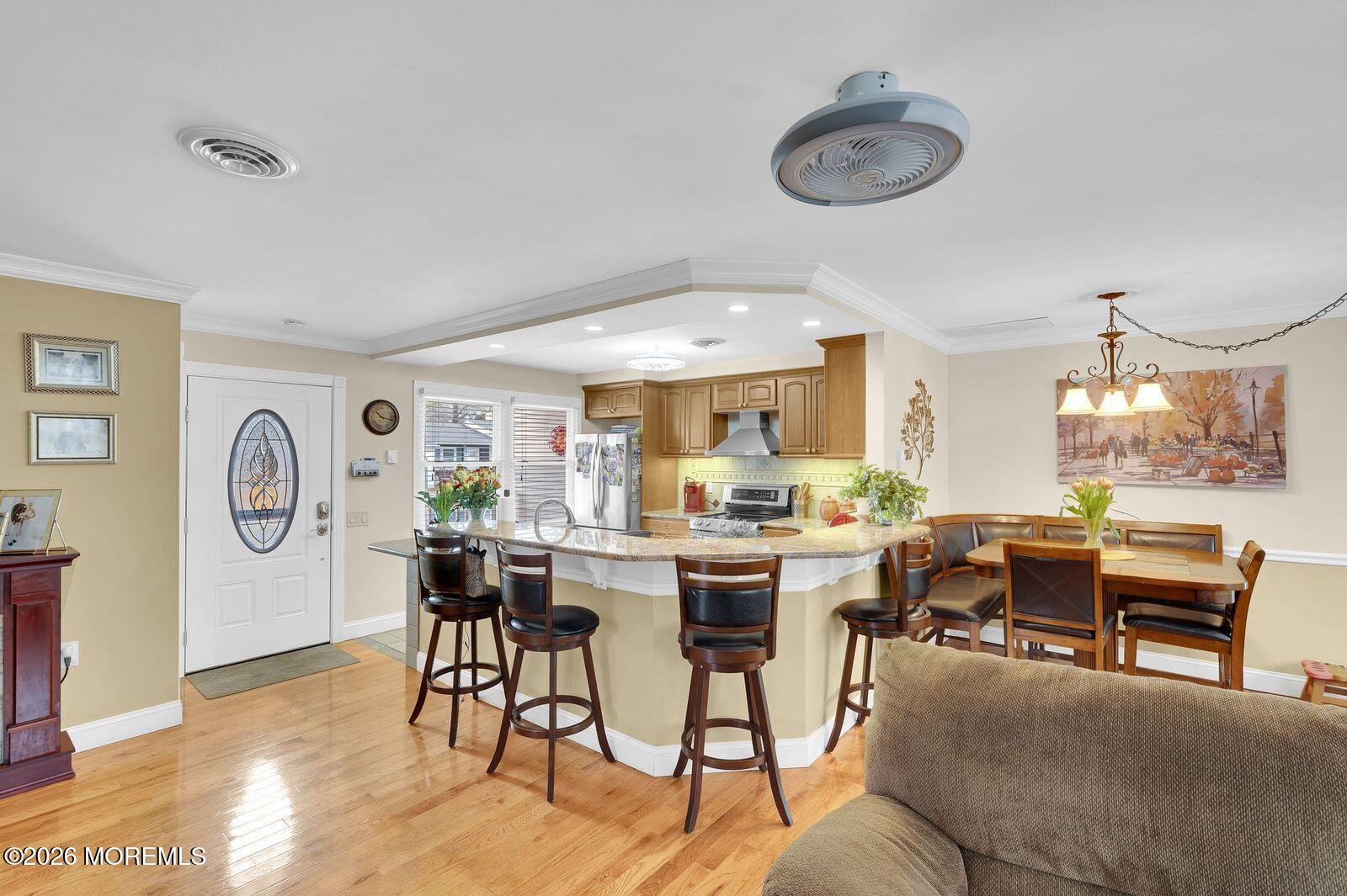 7 Eaton Lane, Unit 73 Whiting, NJ 08759 - Photo 18 of 37 a view of a dining room and livingroom with furniture a rug a fireplace and a large window