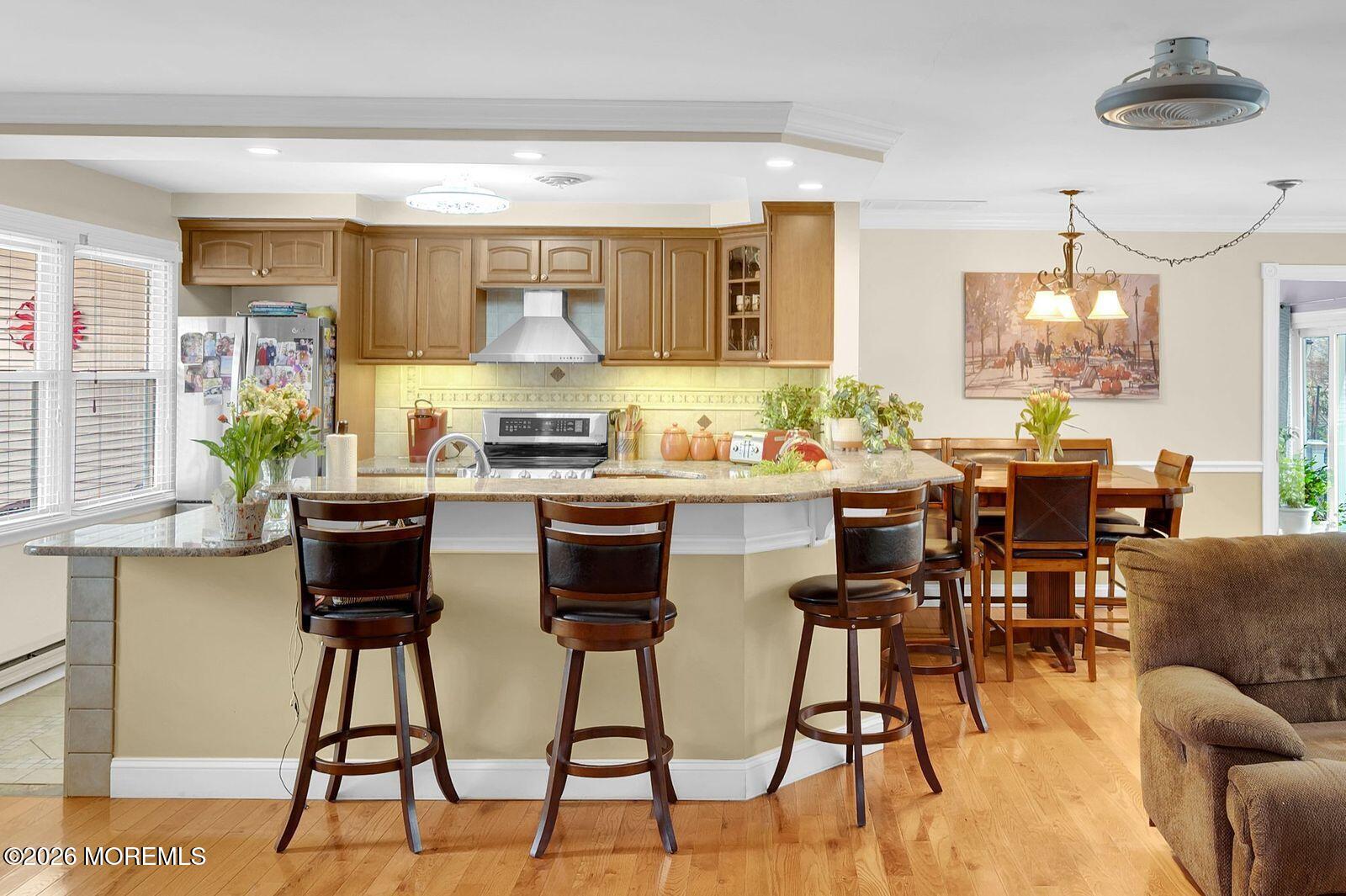 7 Eaton Lane, Unit 73 Whiting, NJ 08759 - Photo 21 of 37 a kitchen with stainless steel appliances kitchen island granite countertop a table and chairs in it