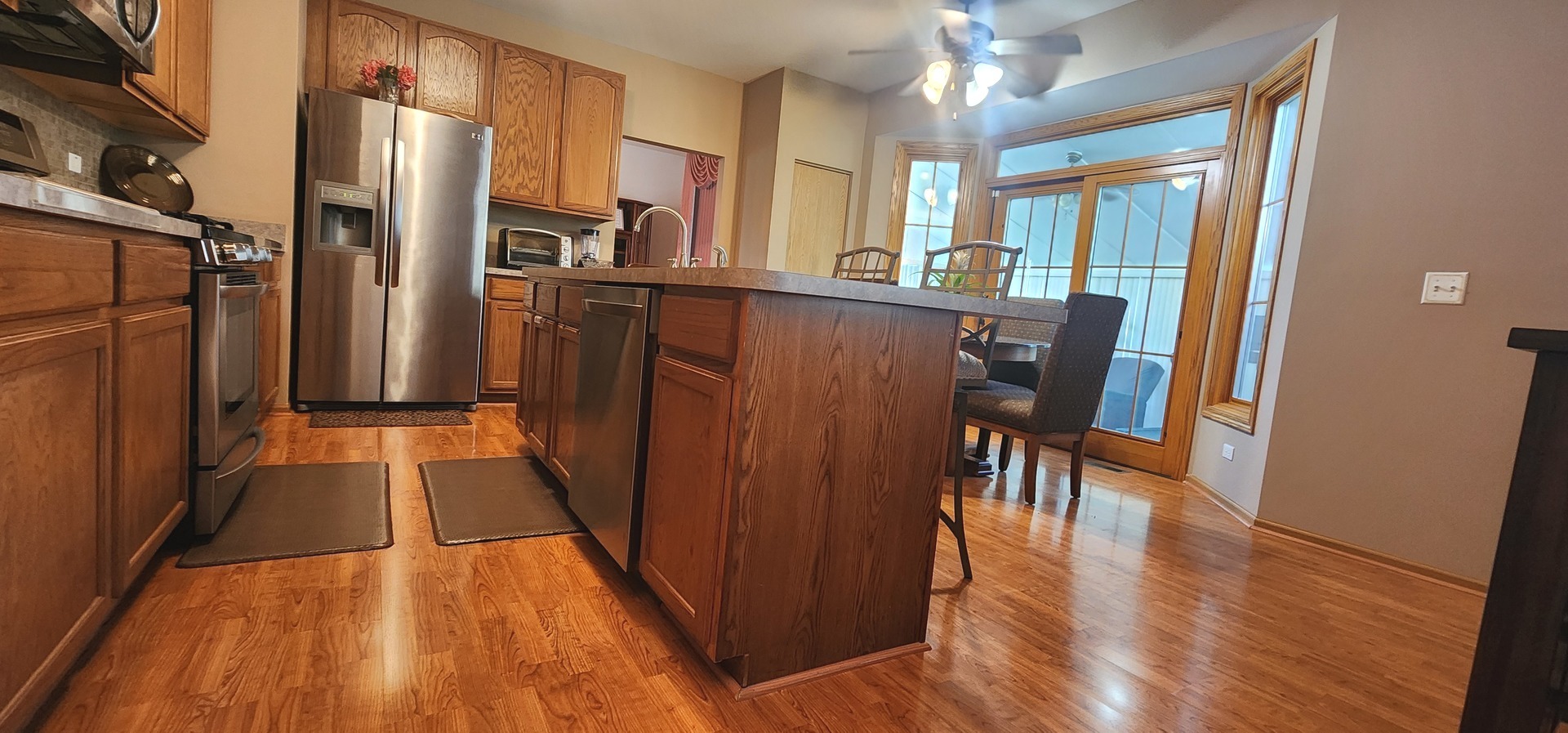 113 Sundance Road Matteson, IL 60443 - Photo 20 of 47 a view of a kitchen with refrigerator and wooden floor