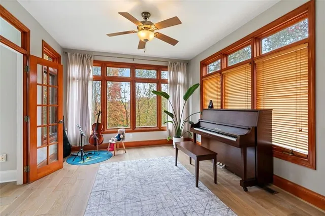 a living room with furniture a fireplace and a large window