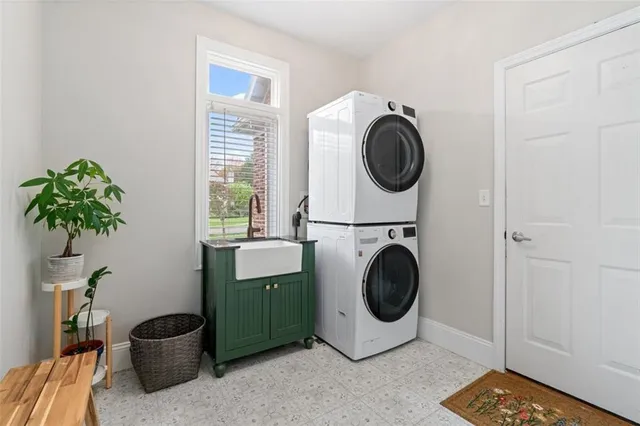 a utility room with sink dryer and washer