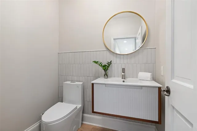 a bathroom with a sink mirror and toilet