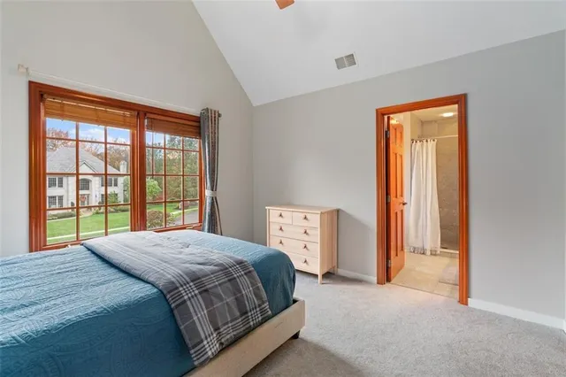 a bedroom with a bed and a large window