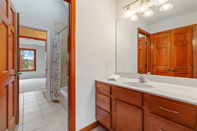 a en suite bathroom with a sink a mirror and a shower