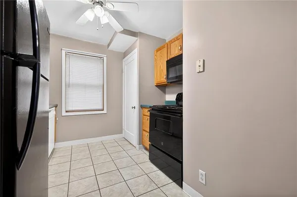 a kitchen with a sink a window and cabinets