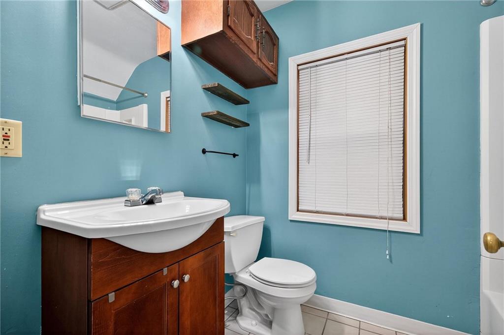 1107 Constitution Street Tarentum, PA 15084 - Photo 16 of 42 a bathroom with a sink toilet and mirror