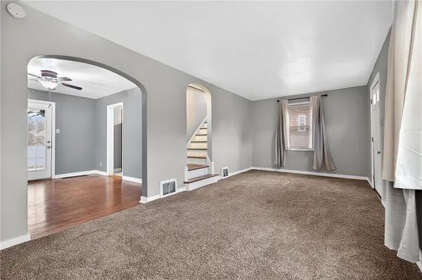 an empty room with windows and closet