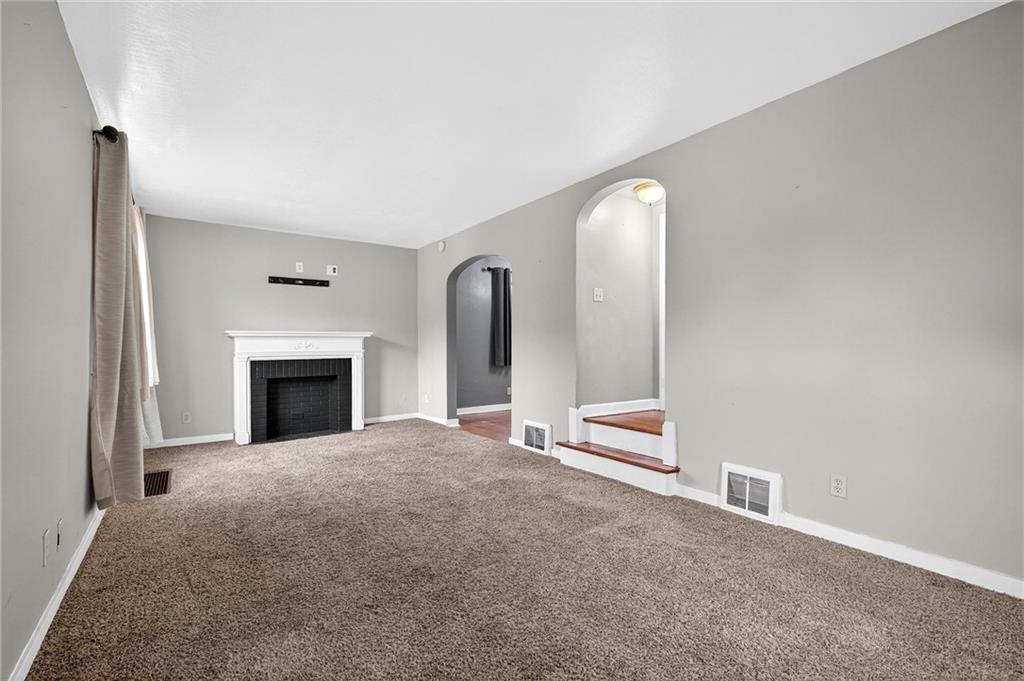 1107 Constitution Street Tarentum, PA 15084 - Photo 7 of 42 a view of an empty room with a fireplace