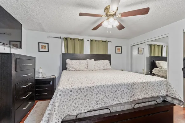 a bedroom with a bed and wooden floor