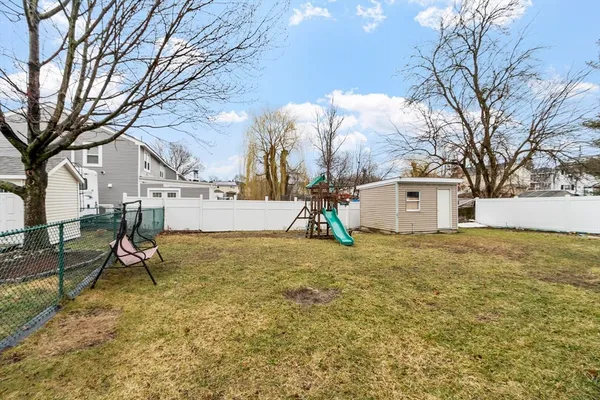 a backyard of a house with table and chairs
