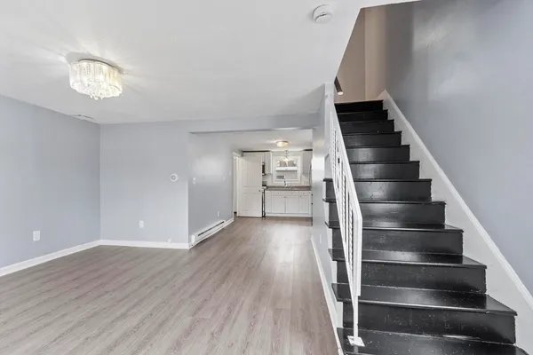a view of entryway and hall with wooden floor
