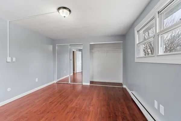 a view of a room with wooden floor and windows