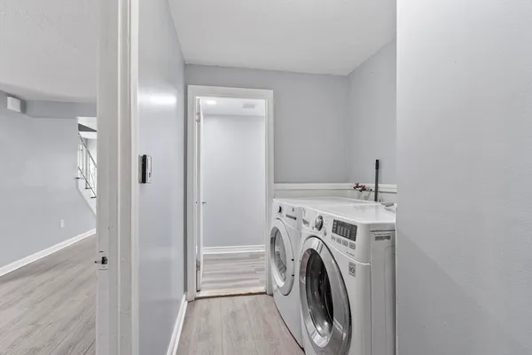 a view of a hallway with washer and dryer