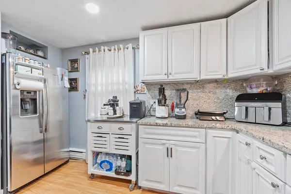 a kitchen with stainless steel appliances granite countertop a refrigerator sink and cabinets