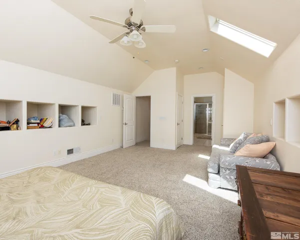 a bathroom with a granite countertop sink a toilet and shower