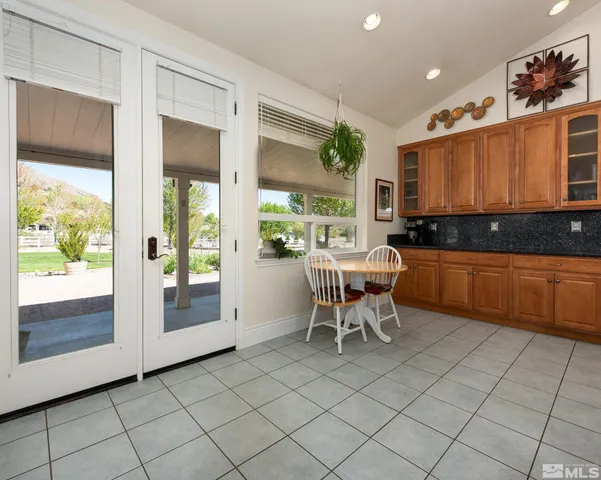 a kitchen with stainless steel appliances granite countertop a refrigerator and cabinets