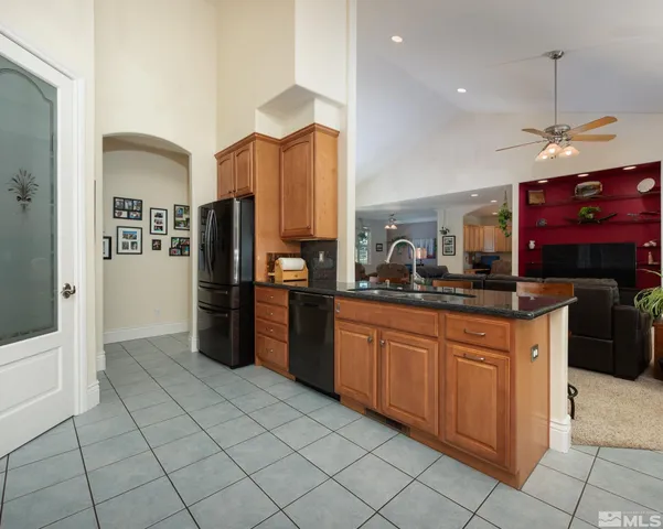 a kitchen with stainless steel appliances granite countertop a sink and cabinets