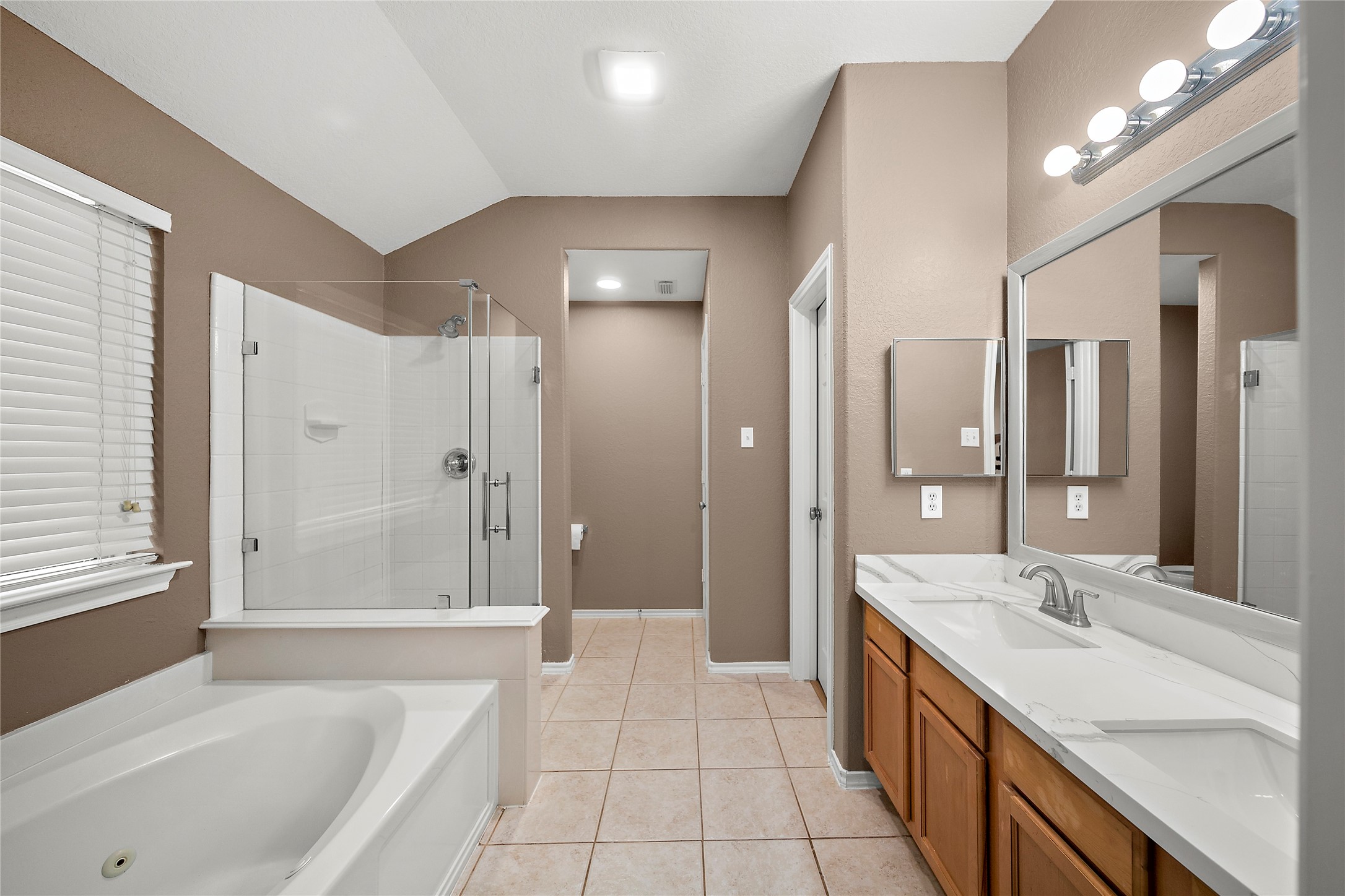 62 Rookwood Court The Woodlands, TX 77382 - Photo 13 of 24 a spacious bathroom with a bathtub shower sink and mirror