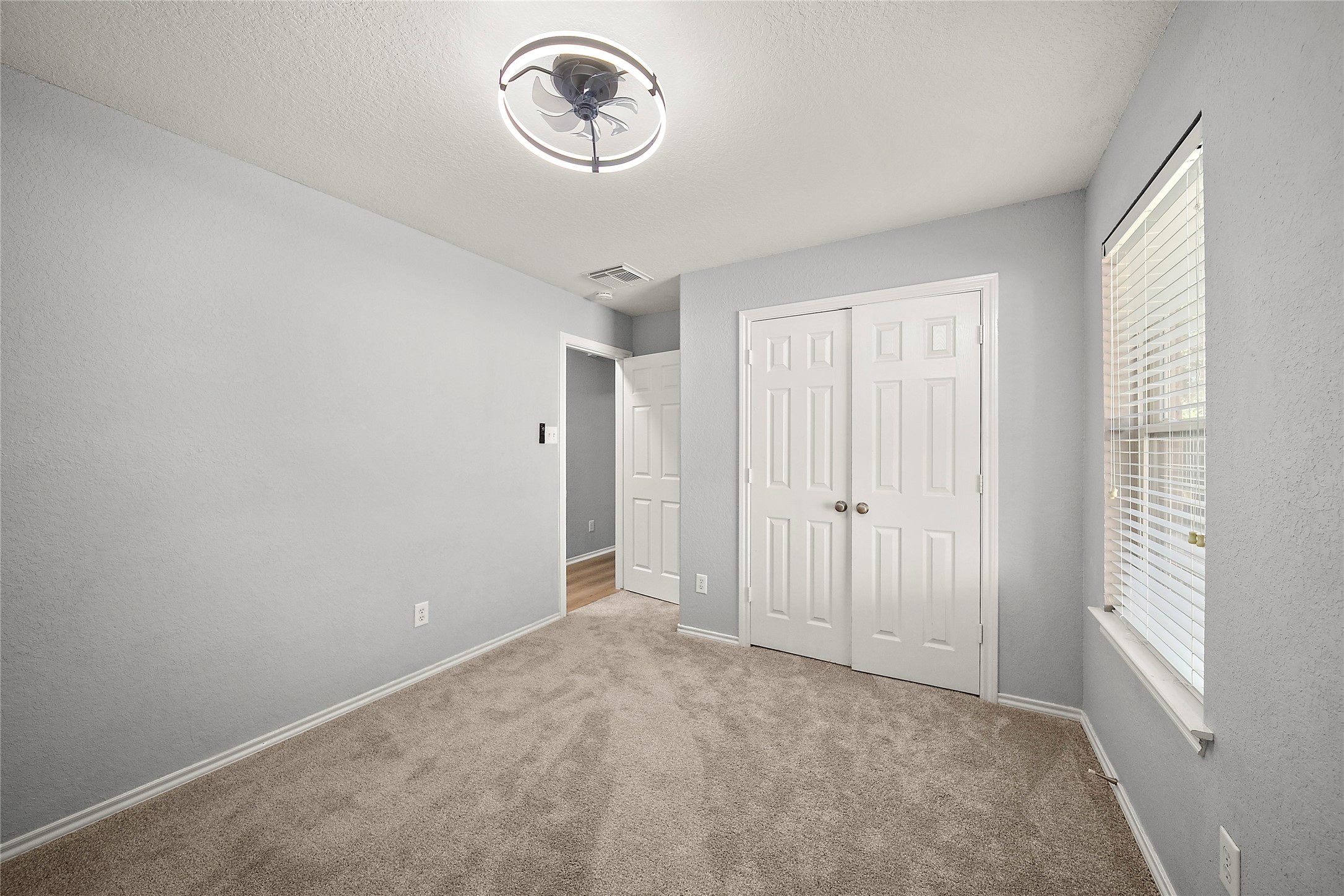 62 Rookwood Court The Woodlands, TX 77382 - Photo 18 of 24 a view of a room with a hanging light and hardwood floor