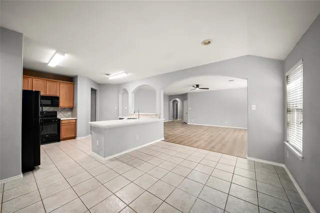 a kitchen with a stove a sink and a microwave