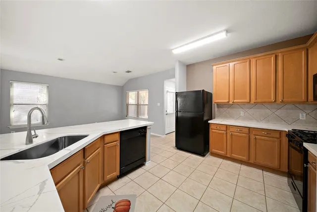 a view of kitchen with kitchen island microwave and view living room