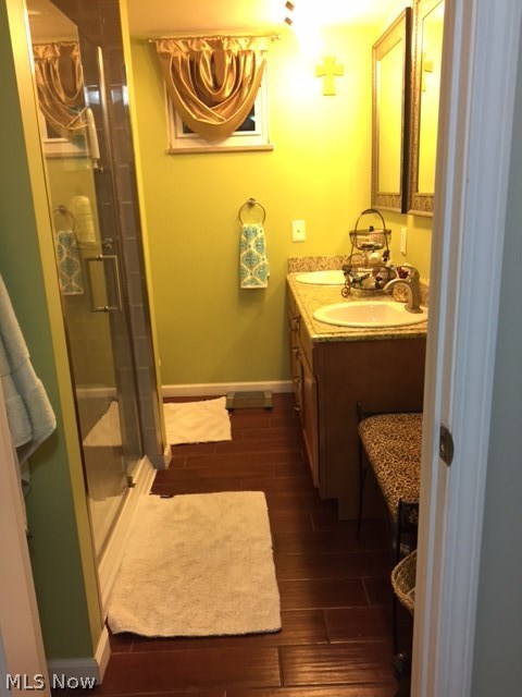 15913 Munn Road Cleveland, OH 44111 - Photo 21 of 31 Master bathroom with wood-look tile, his/hers sinks, large tiled shower with a blue tooth speaker/exhaust fan