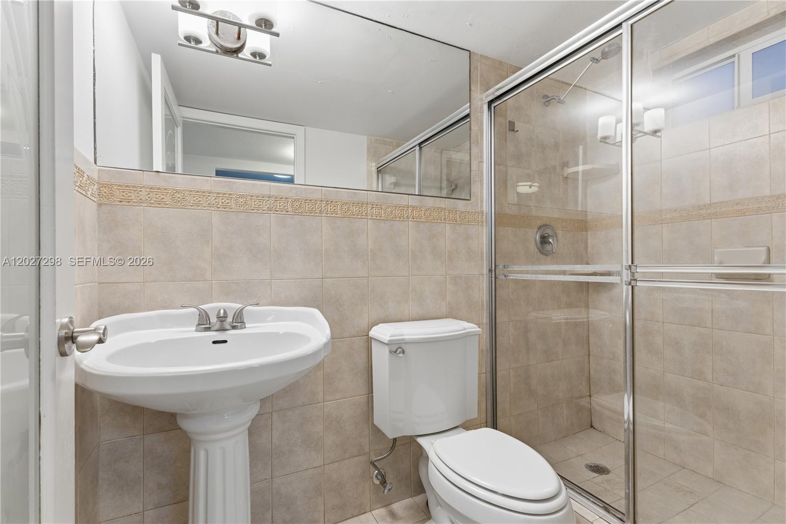 1665 Bay Road, Unit 322 Miami Beach, FL 33139 - Photo 9 of 24 a bathroom with a sink toilet and shower