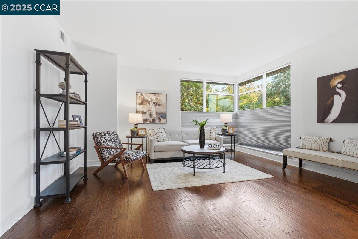 555 Ygnacio Valley Road, Unit 204 Walnut Creek, CA 94596 - Photo 15 of 38 a living room with furniture and a wooden floor