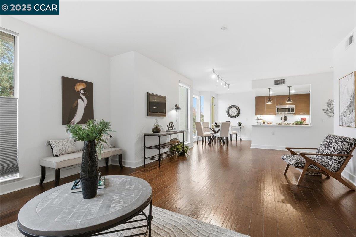 555 Ygnacio Valley Road, Unit 204 Walnut Creek, CA 94596 - Photo 16 of 38 a living room with furniture and wooden floor