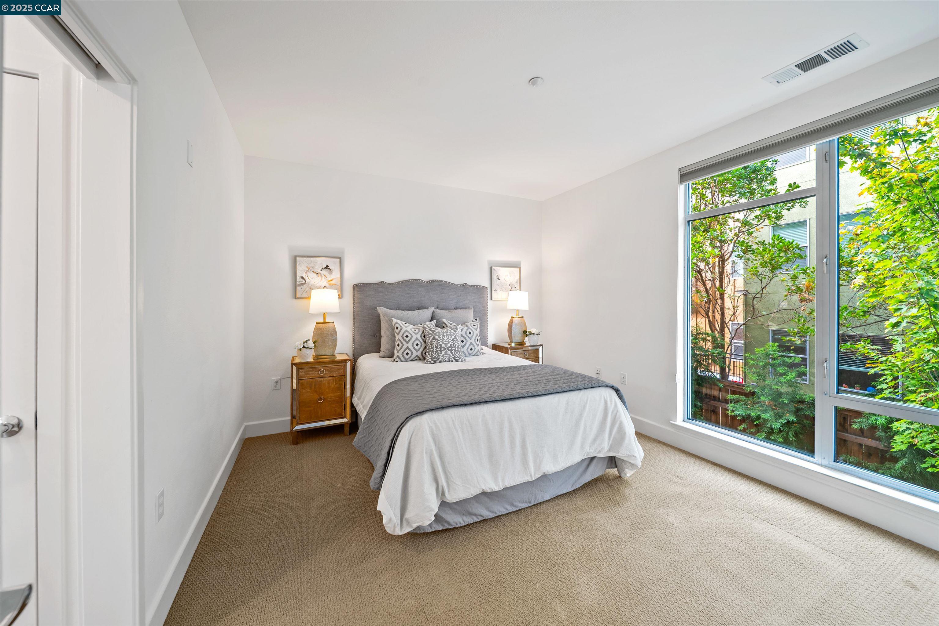 555 Ygnacio Valley Road, Unit 204 Walnut Creek, CA 94596 - Photo 20 of 38 a bedroom with a bed and a large window