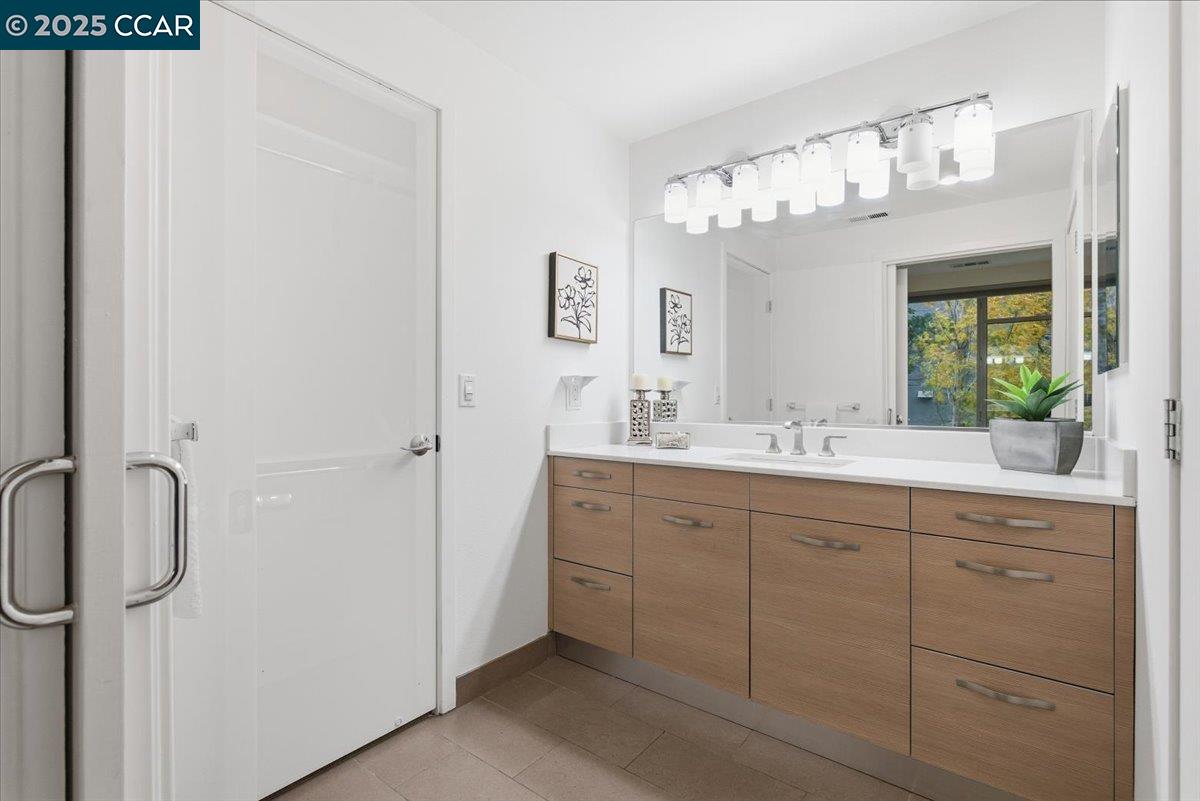 555 Ygnacio Valley Road, Unit 204 Walnut Creek, CA 94596 - Photo 37 of 38 a bathroom with a double vanity sink and a mirror