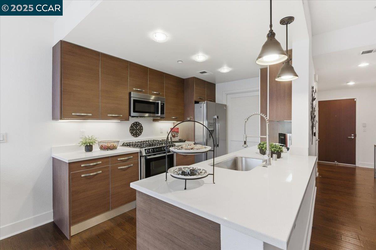555 Ygnacio Valley Road, Unit 204 Walnut Creek, CA 94596 - Photo 5 of 38 a kitchen with a sink stainless steel appliances and cabinets