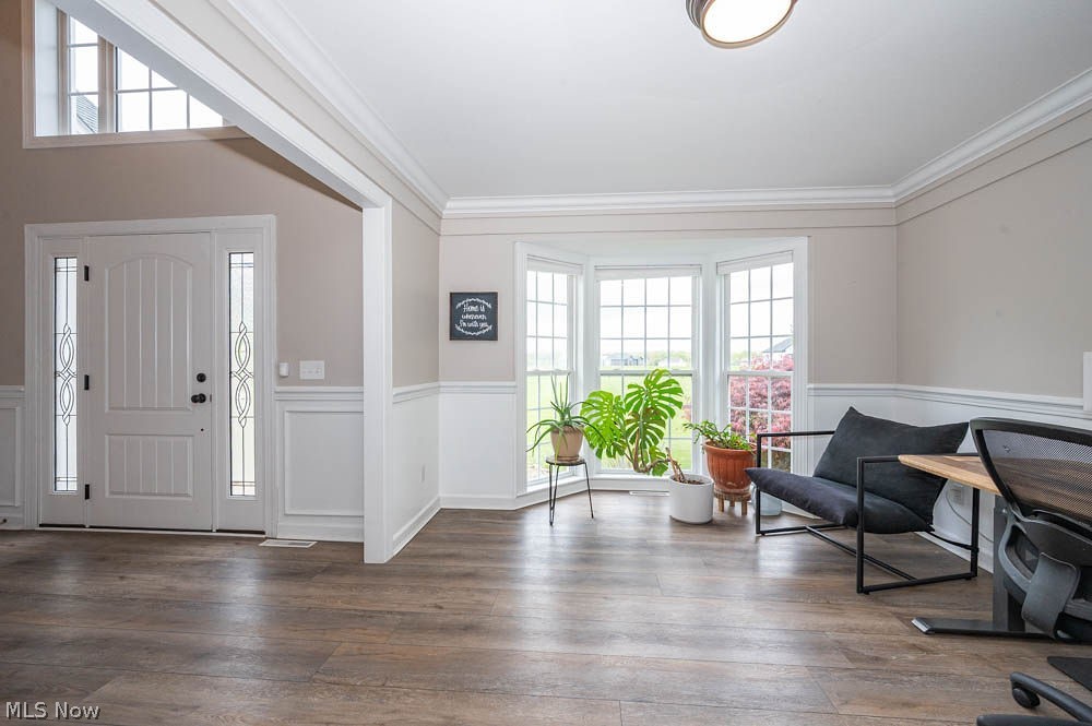 6787 South Palmyra Road Canfield, OH 44406 - Photo 5 of 30 Entryway featuring a decorative front door with sidelights and transom window, wood-finish flooring, wainscoting, crown molding, and a bay window
