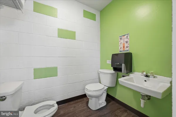 a bathroom with a toilet sink and mirror
