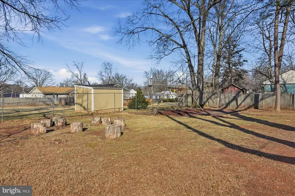 a view of a yard with wooden fence