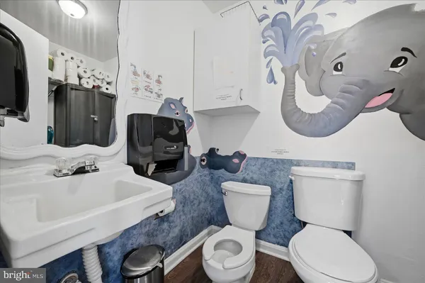 a bathroom with a toilet sink and mirror