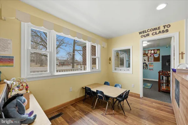 a view of a dining room with furniture window and wooden floor