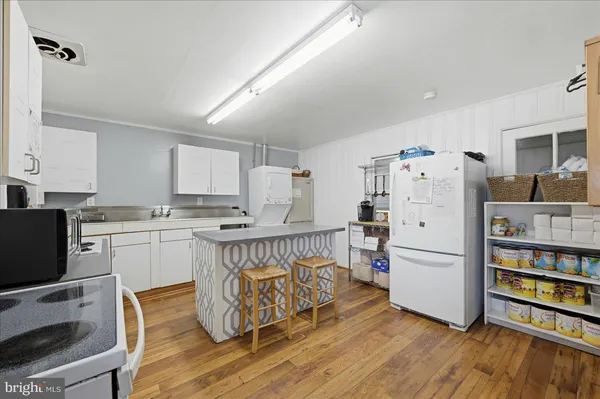 a kitchen with cabinets and wooden floor