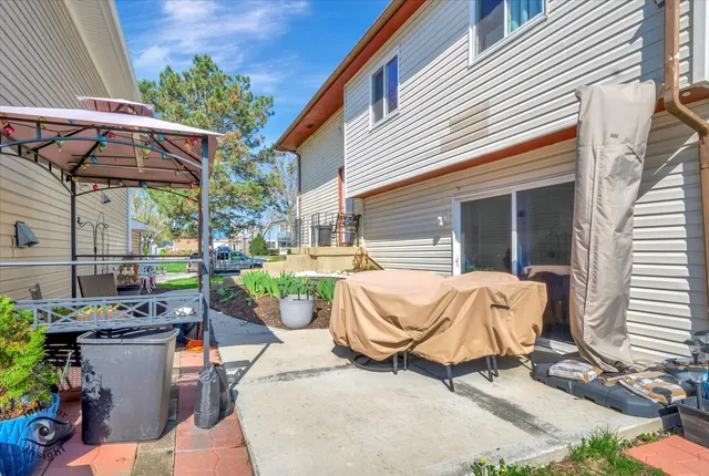 a view of a patio with table and chairs and potted plants