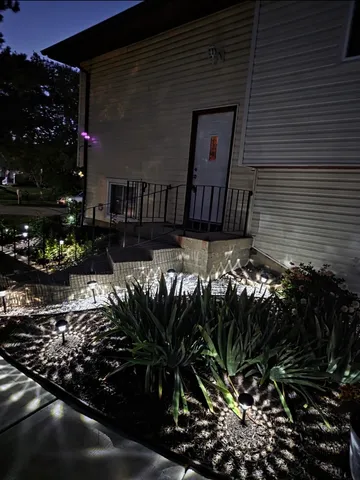 a view of a house with a flower garden