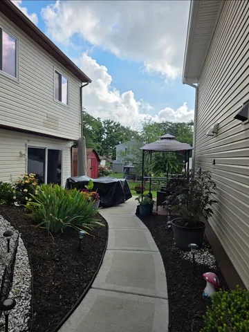 a view of a house with backyard sitting area and garden