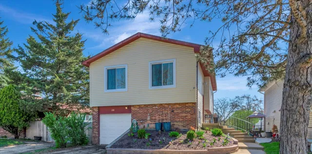 a view of house with tree in front of it