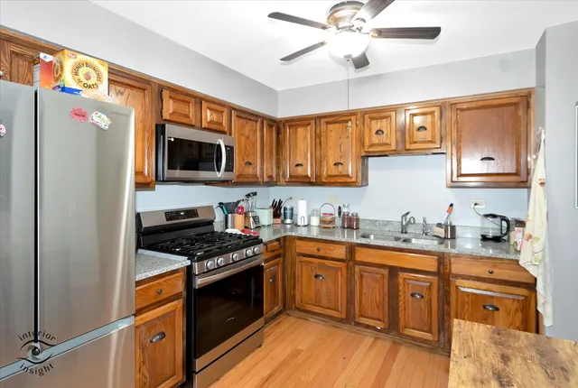 a kitchen with stainless steel appliances a stove a sink and a refrigerator