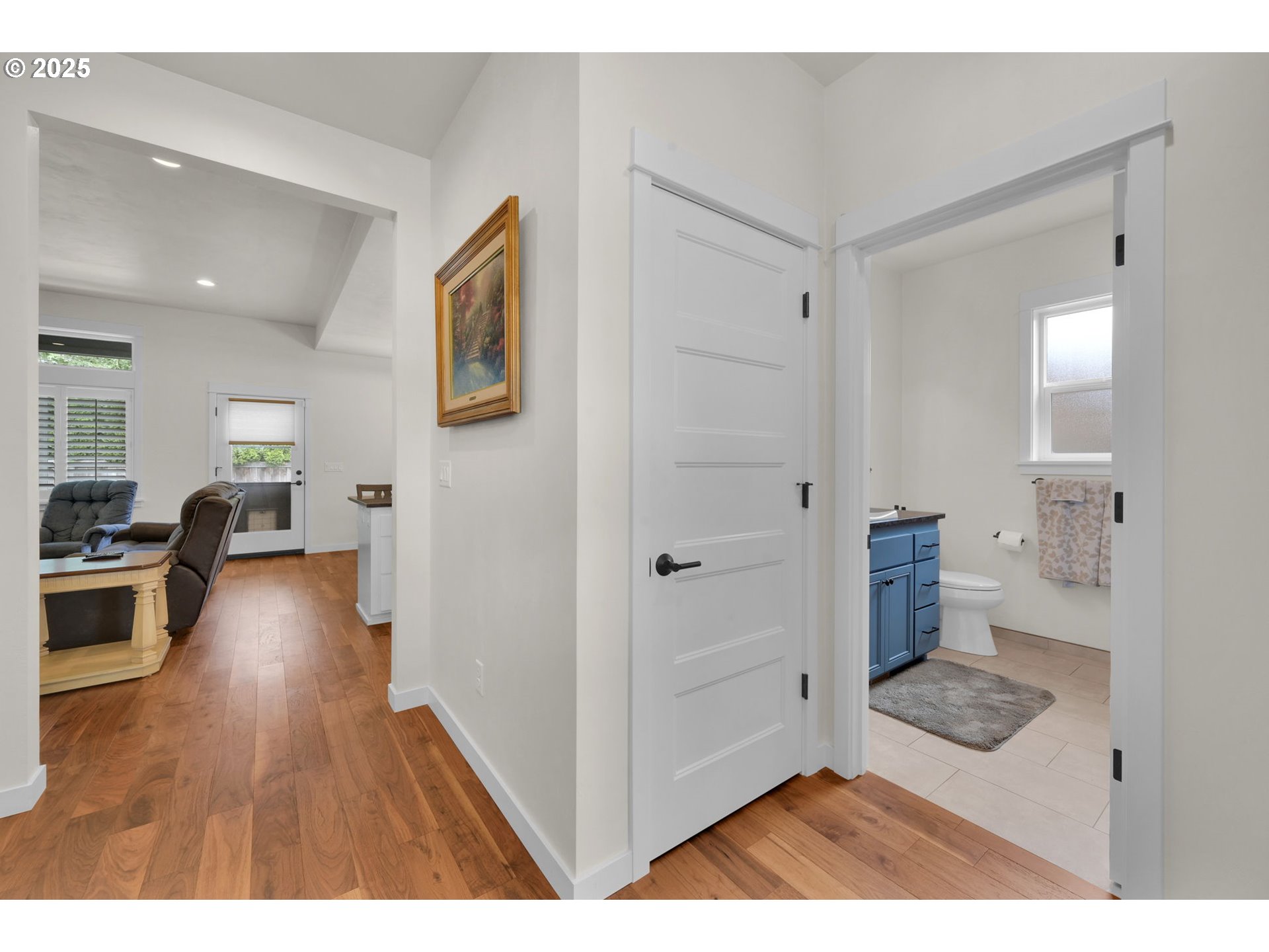 970 Lupine Street Springfield, OR 97477 - Photo 27 of 47 a view of a hallway with wooden floor windows and a living room