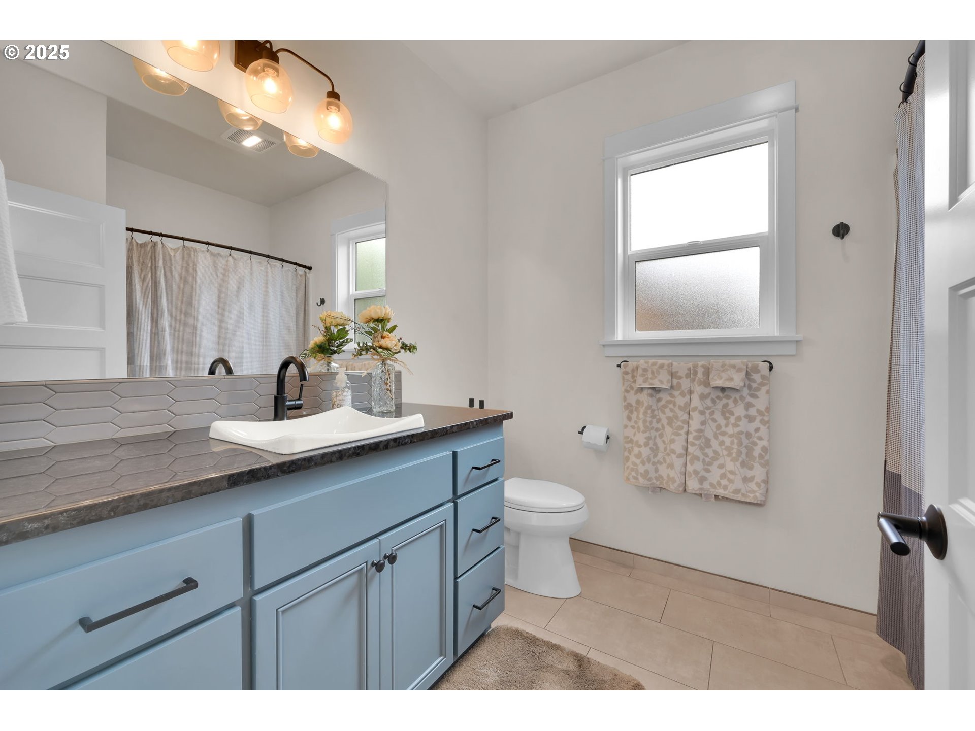 970 Lupine Street Springfield, OR 97477 - Photo 31 of 47 a bathroom with a granite countertop sink mirror vanity and toilet