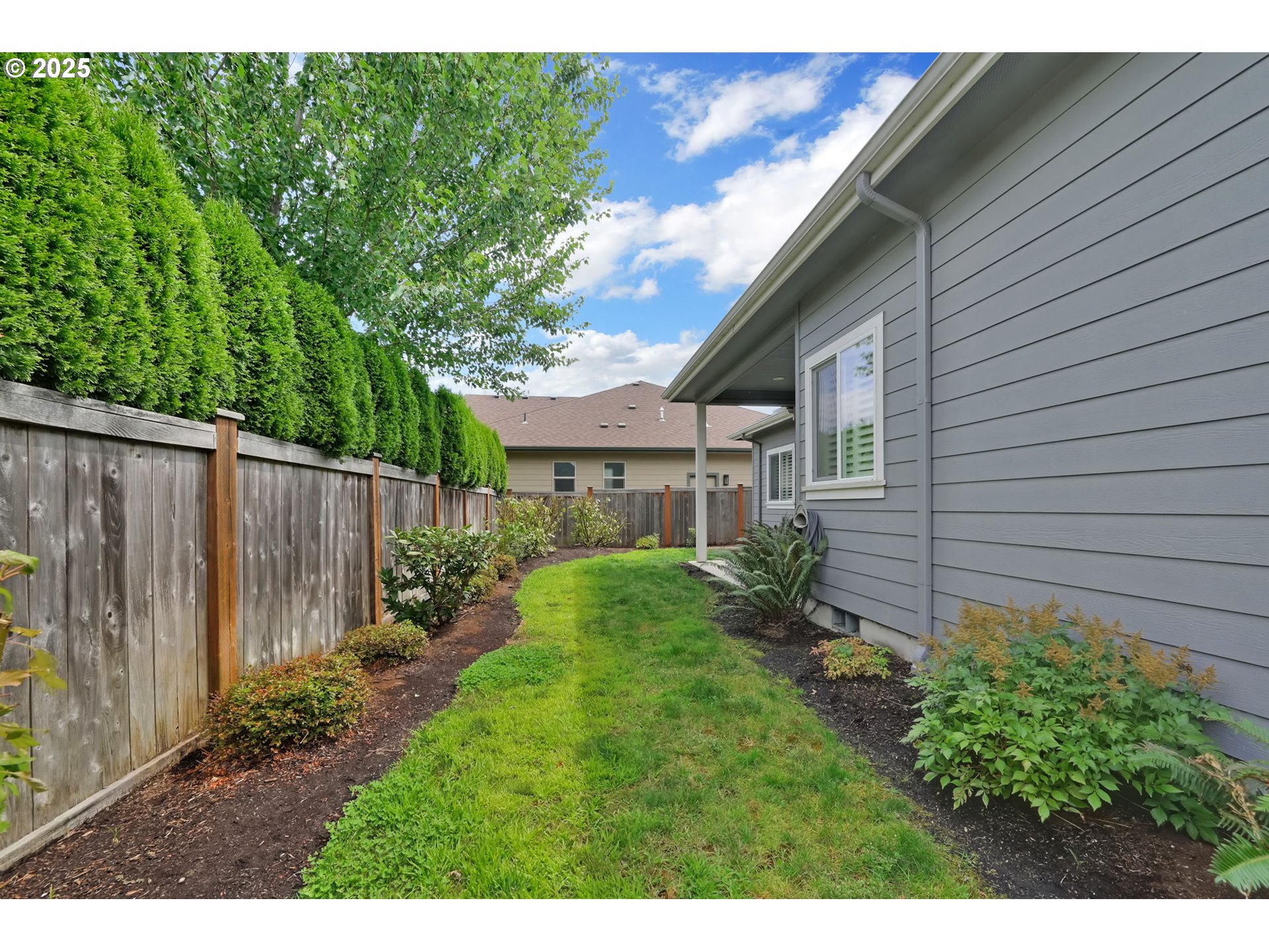 970 Lupine Street Springfield, OR 97477 - Photo 45 of 47 a view of backyard with potted plants and wooden fence