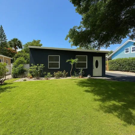 a view of a house with backyard and porch