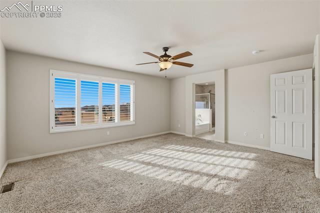 2224 Reed Grass Way Colorado Springs, CO 80915 - Photo 28 of 39 Unfurnished bedroom with ceiling fan, carpet, and ensuite bathroom
