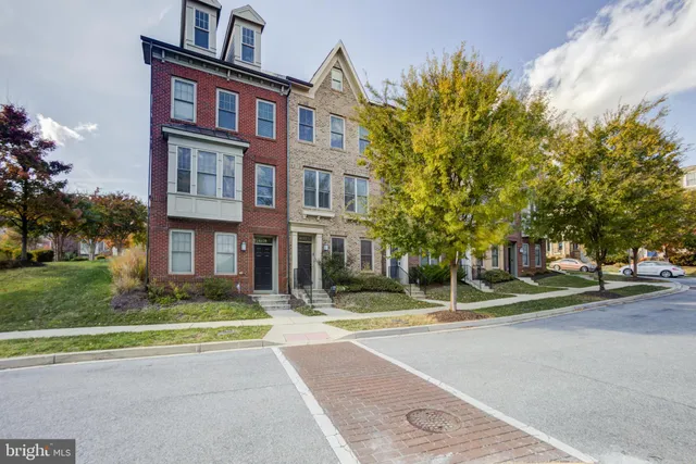 a front view of a residential apartment building with a yard
